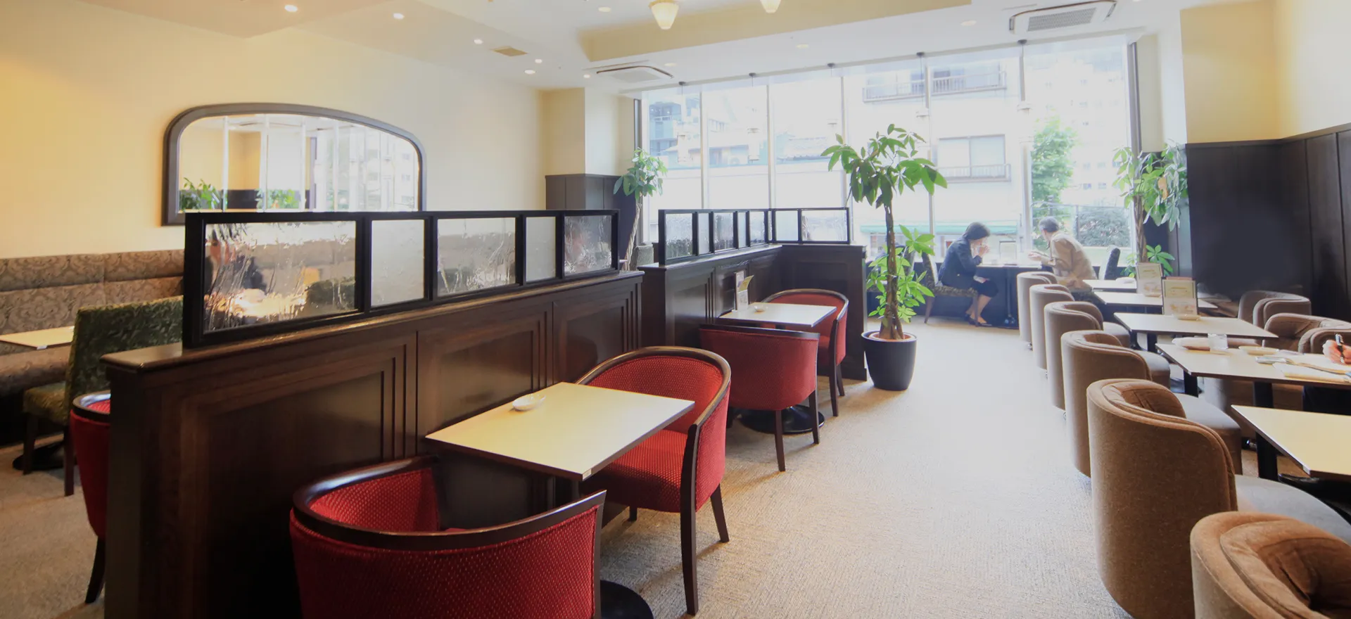 テーブル席とソファ席を備えた明るいラウンジスペース